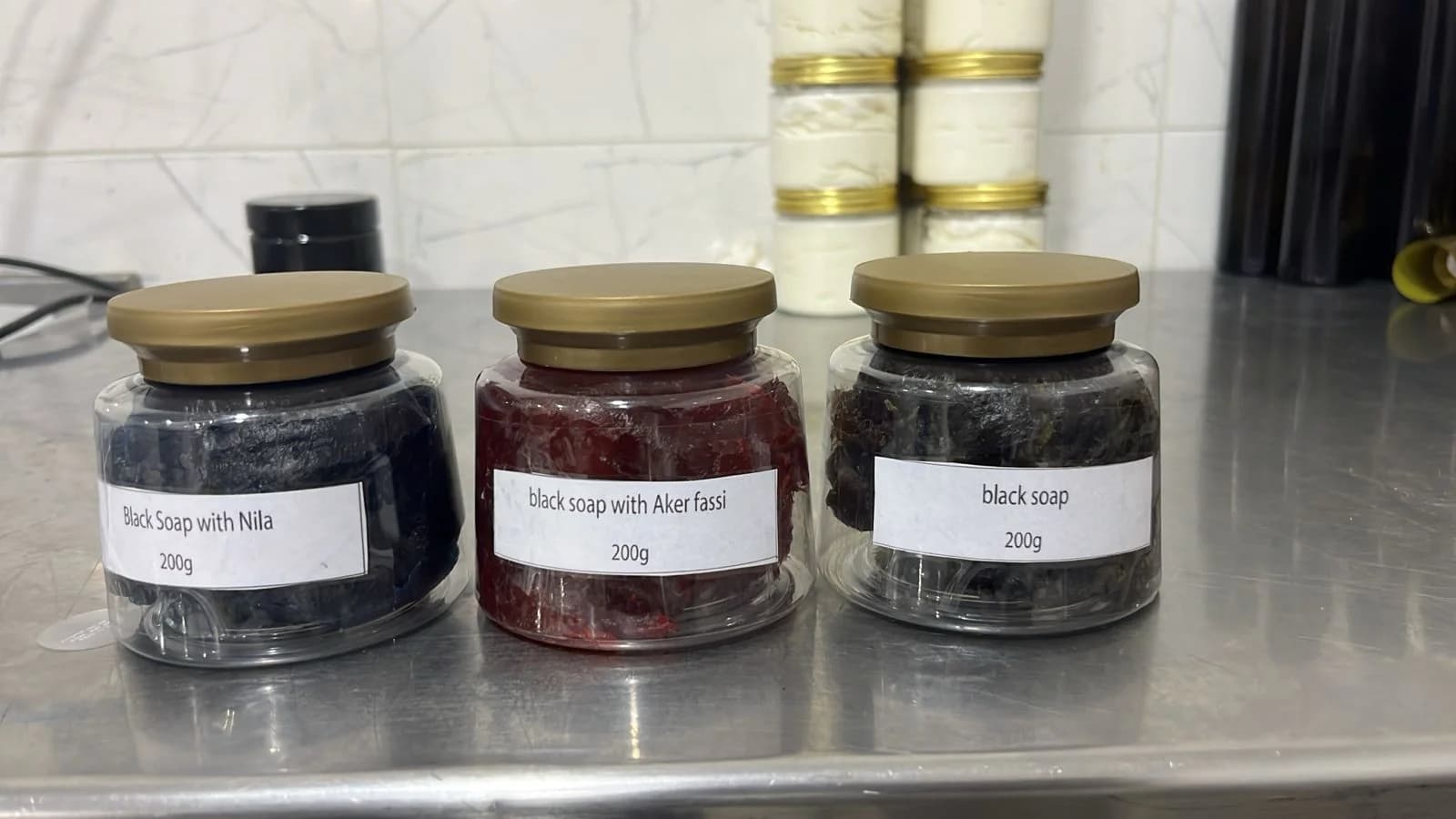Moroccan hammam products staged for export on a stainless steel work surface